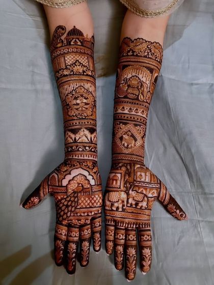 A traditional design filled with classic motifs like peacocks, elephants, and architectural domes.