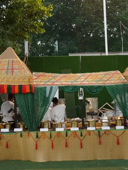 I bring tradition to life with detailed themed counters. This village-style setup features jute and bamboo elements, creating an authentic backdrop for serving classic Indian regional dishes.