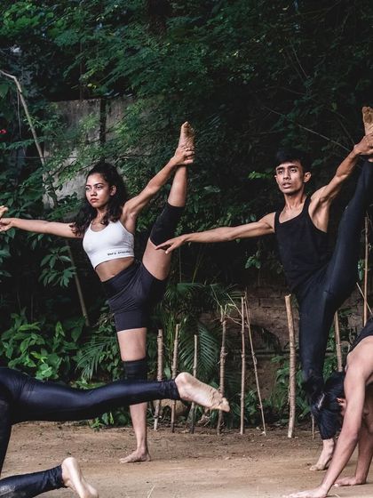 A complex group formation from a contemporary dance performance. This image highlights the balance, flexibility, and synchronization our dancers achieve through dedicated training.