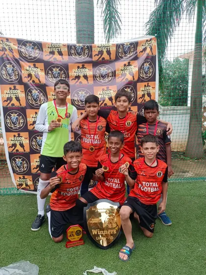 The U13 champions of the 5v5 Sports Cup 3.0, posing with their winners' shield and medals.