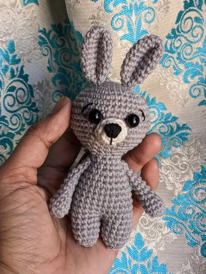 The bunny keychain held in hand.