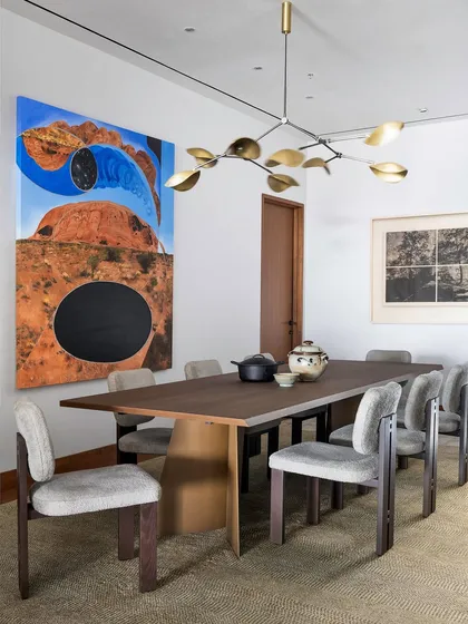 Our work extends to the complete curation of a home's interior. In the Worli Duplex dining room, we selected furniture and art that complement the architectural language, creating a sophisticated space for gathering that balances form, function, and artistic expression.