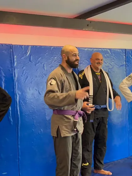 Coaches and senior members together during promotions. Leadership and experience guide our team.