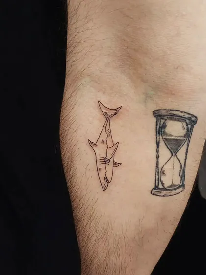 A quirky combination of a small shark and an hourglass. This tattoo can symbolize the powerful and relentless nature of time.