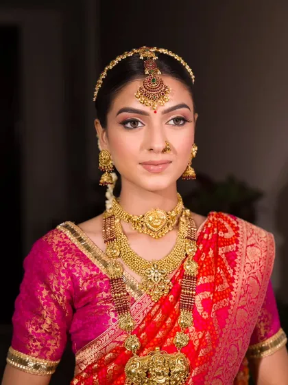 A close-up of this stunning South Indian inspired look. The makeup is classic and golden, perfect for a traditional event.