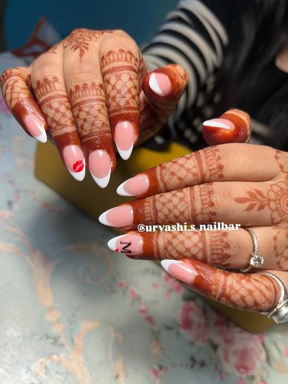 A playful twist on the classic French manicure for a bride. I added a tiny hand-painted kiss mark and an initial to make this set personal and unique.