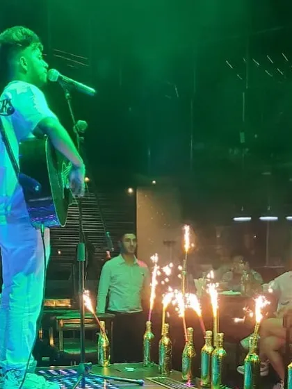 Making a grand entrance with sparklers and my guitar. This is how we add that extra flair to a celebration, making it a spectacular night for everyone.