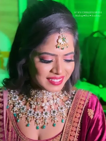 A close-up of a glamorous reception look. The focus is on the dramatic pink and shimmery eye makeup, paired with a bold lip, creating a look that is both festive and elegant.