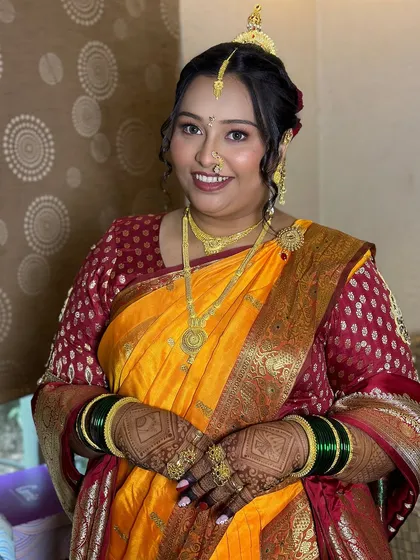 A complete look at the bride's traditional Maharashtrian wedding day style, from her makeup to her jewelry.
