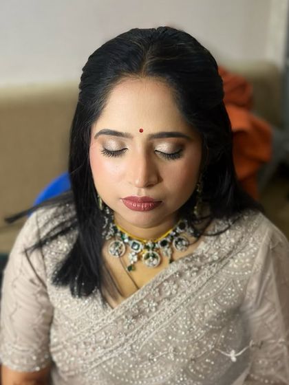 A very subtle and minimalistic reception look, with a focus on glowing skin and soft, shimmery eyes.