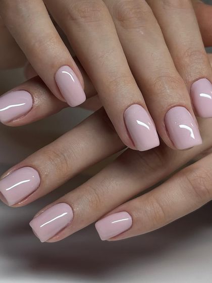 A soft, classic pink manicure on square-shaped nails. This timeless and feminine color is always a popular choice.