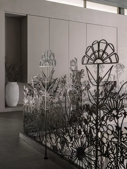 The delicate yet strong forms of the metal railing create a beautiful screen that allows light to pass through. This piece demonstrates how functional safety features can also be exquisite works of art.