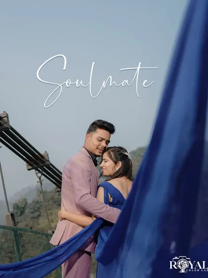 An intimate close-up of a couple on the bridge, framed by the bride's flowing blue dress, creating a sense of privacy and connection.