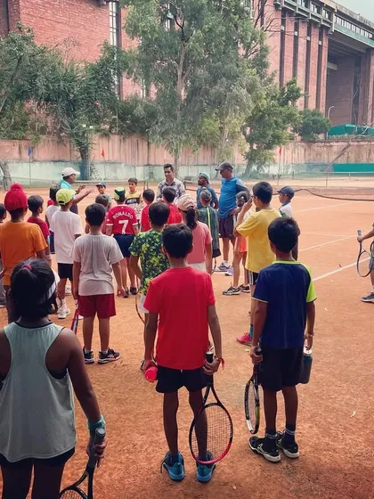 A group of our young players listening intently to their coach. We start teaching strategy and focus from the very beginning.