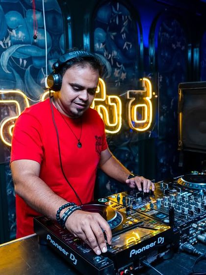 At the controls at Sarjapur Social, with the neon Kannada sign glowing in the background. I love playing at venues that have a unique local touch.