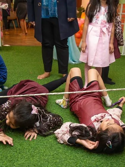 That's how you win at limbo! These girls know how to get low to the ground.