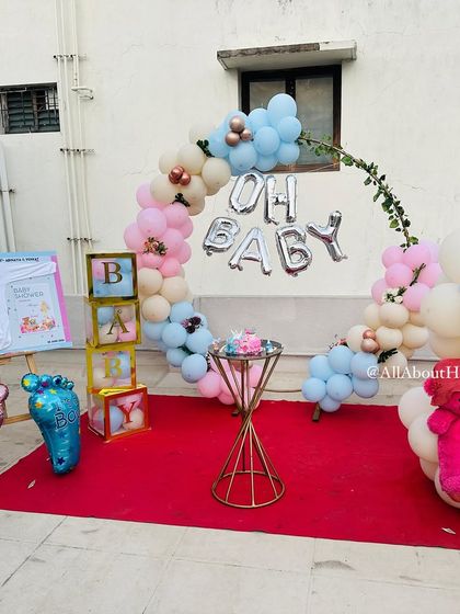 We set up this sweet "Oh Baby" decor on a client's terrace for a baby shower. The hoop backdrop with pastel balloons and teddy bear accents created a lovely and intimate celebration space.