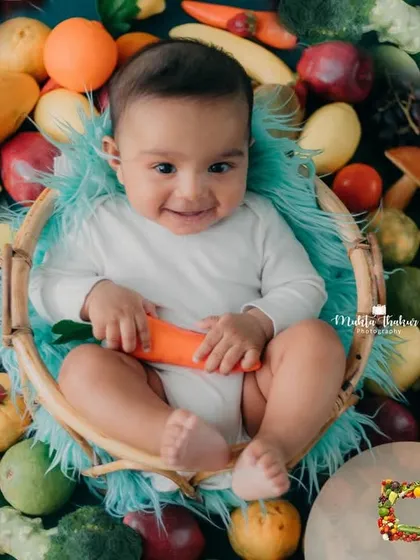That contagious smile is the best. This 5-month-old is enjoying his colorful and healthy Holi-themed photoshoot.