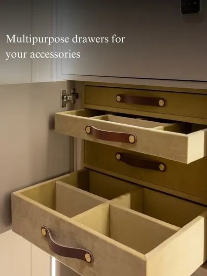 These velvet-lined, multipurpose drawers are perfect for organizing accessories like watches, belts, and jewelry. The soft leather pulls add a tactile, luxurious detail to the custom wardrobe.