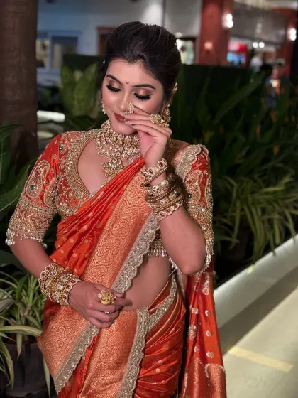 A candid shot of the bride in her red Nauvari, adjusting her nose ring.