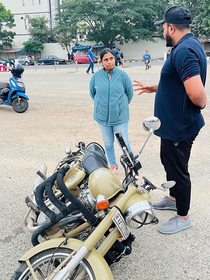 Discussing the situation after a bike has been dropped. These are valuable learning moments, not failures, and we address them with patience and practical advice.