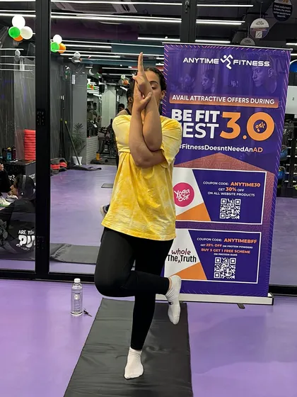 This member shows her strength and balance while participating in the Eagle Pose challenge.