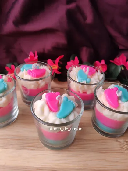 Aren't these the cutest baby shower candles ever? These shot glass candles feature layers of pink and blue wax with tiny baby footprints on top. They are a delightful and memorable favor.