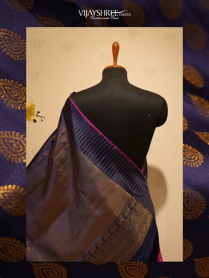 The saree features a striped pallu and a simple, elegant border.