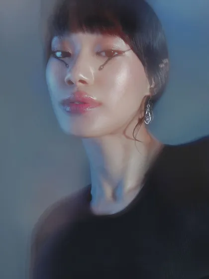 The same graphic eyeliner look under cool, blue-toned lighting. This shows how makeup can transform and take on a different mood with a simple change in light.