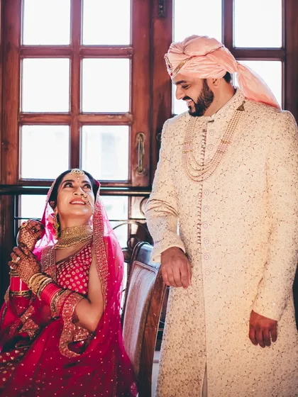 A sweet and classic portrait of the couple, with the bride looking up adoringly at her groom. A timeless shot that captures their love story.