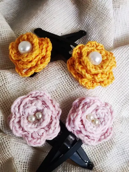 A closer look at the yellow and pink floral hair clips. Each flower is handmade and securely attached to a clip.