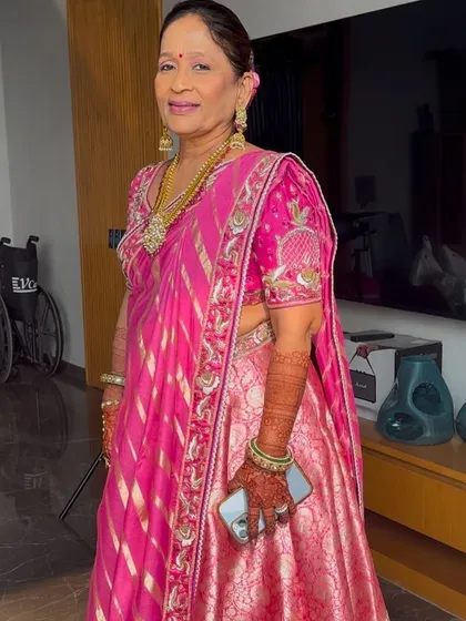 A candid moment showing her getting ready. The makeup is designed to be comfortable and long-lasting for a full day of wedding festivities.