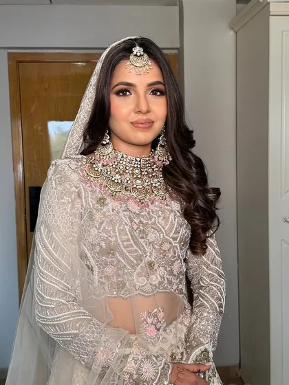 The bride, ready and radiant. The open hairstyle is a modern choice that feels fresh and youthful for a wedding day.
