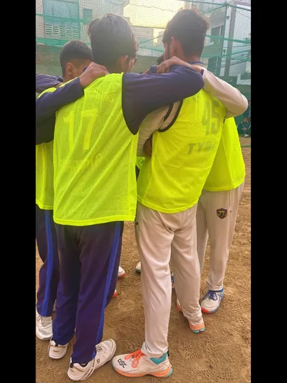 A coach joins the huddle, giving last-minute instructions and encouragement.