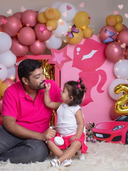 A sweet moment between a father and his daughter during her Barbie party. Even dads can't resist the magic of a makeover from their little girl.
