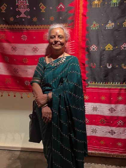 Standing in front of traditional textile displays at the 'Pampa' exhibition in Hampi. It was a proud moment to represent hand embroidery among the rich crafts of Karnataka.