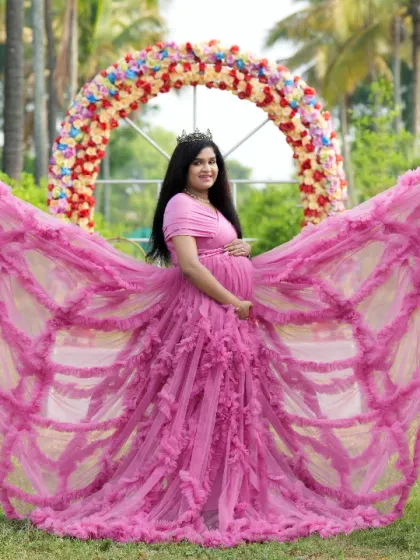 A dramatic butterfly pose with a pink ruffled gown, set against our unique cone-shaped green props.