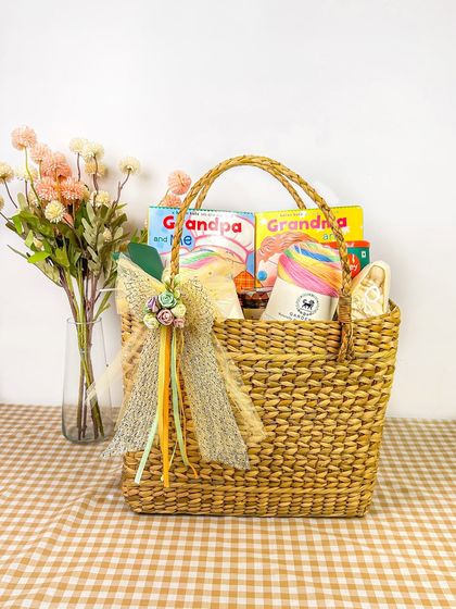 Another view of the grandparents' gift hamper, this time focusing on the beautifully decorated wicker bag. This angle highlights the presentation of the gift.