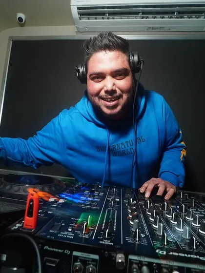 All smiles from the DJ booth. Your party's success is my happiness.