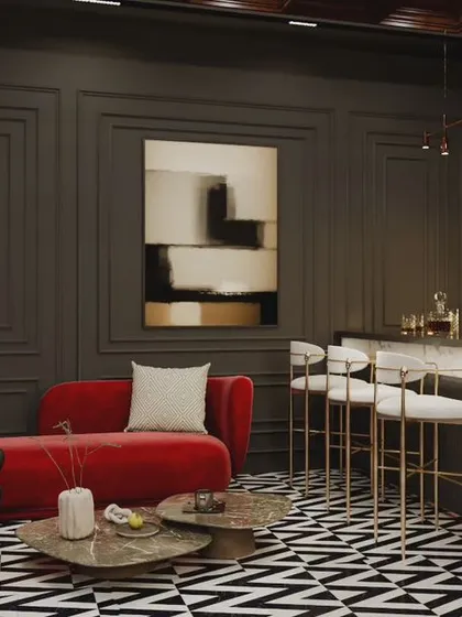 This intimate home bar setup combines dark, paneled walls with a striking black-and-white chevron floor. A pop of color is introduced with a red chaise lounge, creating a chic and inviting corner for cocktails and conversation.