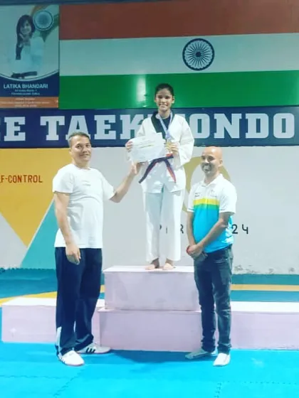 One of our students on the winner's podium at the Peace Taekwondo Fund Raising Championship 2022.