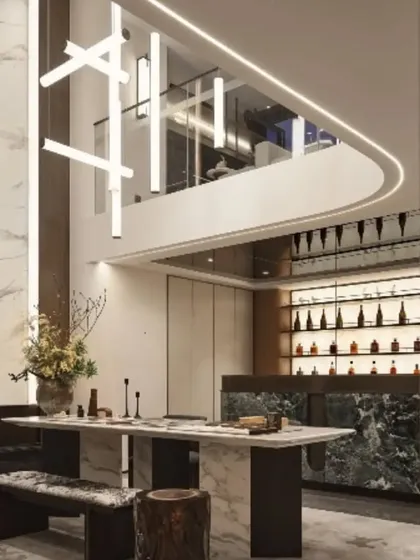 This is an example of a double-height living area in a minimalist luxury bungalow we designed. We used statement lighting and an open-plan layout to create a sense of scale and airiness, complete with a dedicated space for a home bar.