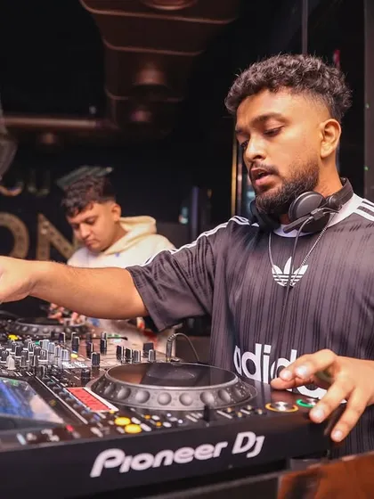 Focused on the mix, ensuring every transition is perfect. Crafting a seamless musical journey is key to maintaining the party's momentum.