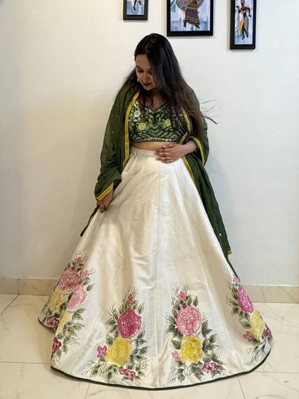 This shot highlights the gorgeous floral painting on the border of the skirt, showing the detail and craftsmanship involved.