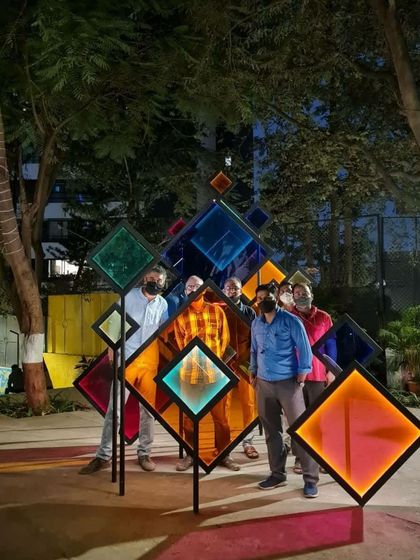 A group poses for a photo within the 'Family Tree' installation. Our goal is to create landmarks that people connect with personally, turning public spaces into backdrops for their own stories.