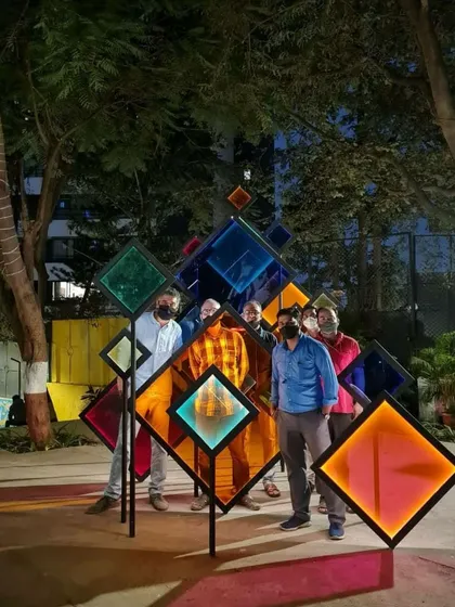 A group poses for a photo within the 'Family Tree' installation. Our goal is to create landmarks that people connect with personally, turning public spaces into backdrops for their own stories.