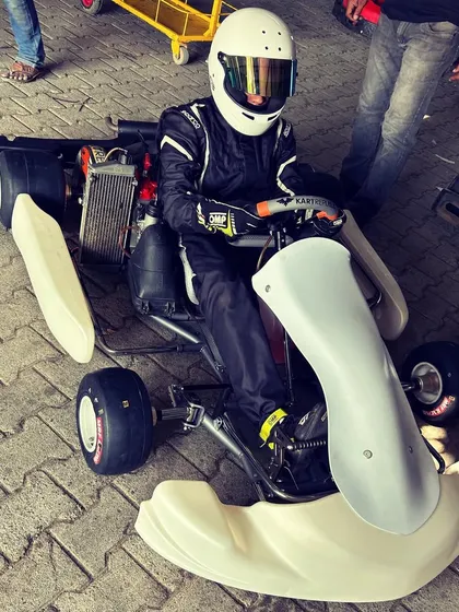 A driver sits in a bare chassis during a fitting.