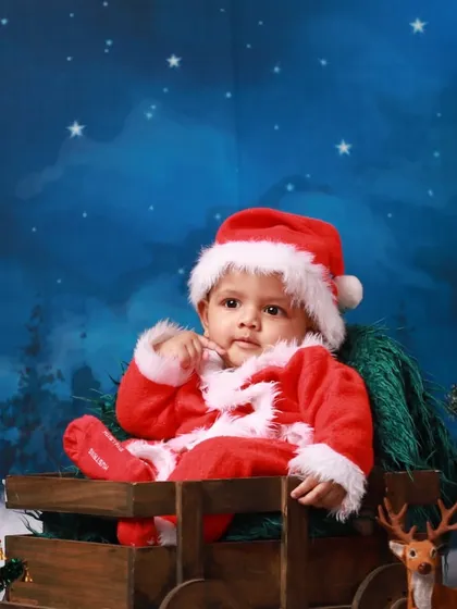 A close-up of our little Santa, capturing a curious and sweet expression. The soft, plush Santa suit and hat are part of the wardrobe I provide for my festive holiday sessions.
