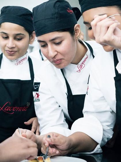 Students gathered around, learning the finer points of a classic recipe. Our small class sizes ensure everyone gets a close look and personalized guidance.