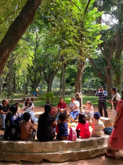 A wide view of our storytelling circle, where families gather on mats to listen. This setup creates a cozy and inclusive environment for everyone to feel part of the Green Panther community.